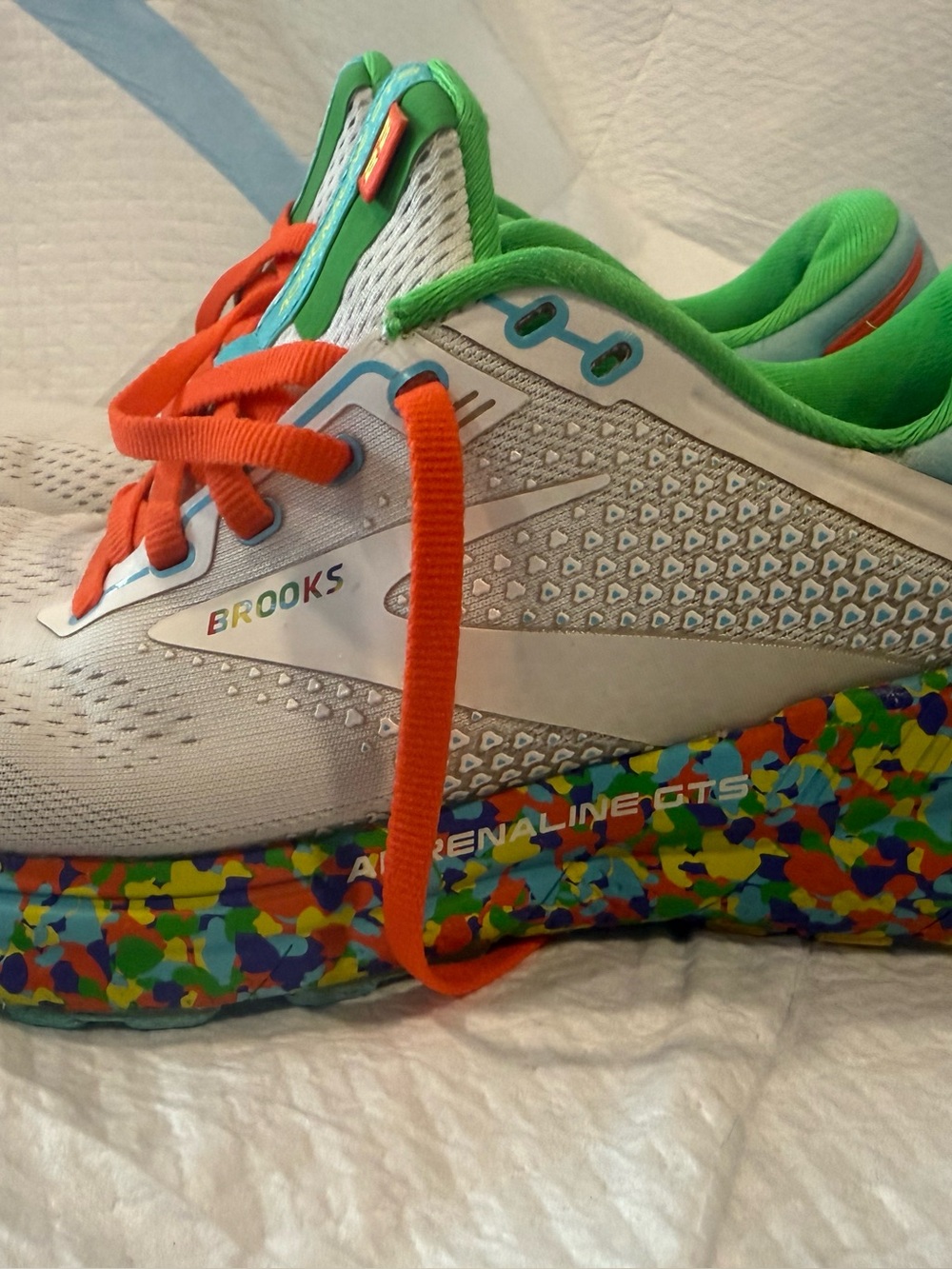 Brooks women’s ' White Adrenaline GTS Running Shoe with Green and Orange Accents